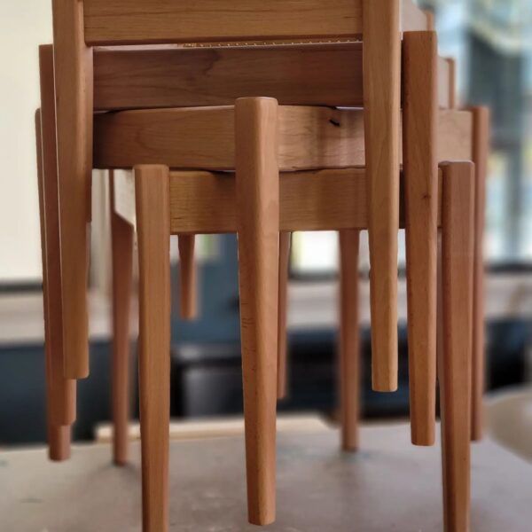three handmade wooden stools stacked