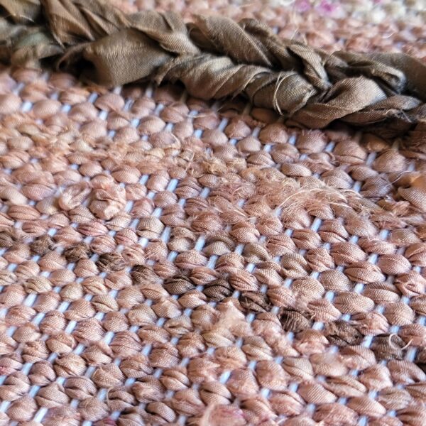 close up of handwoven silk fabric of a wall hanging