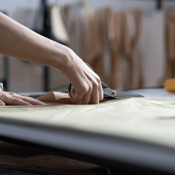 hands cutting and measuring fabric