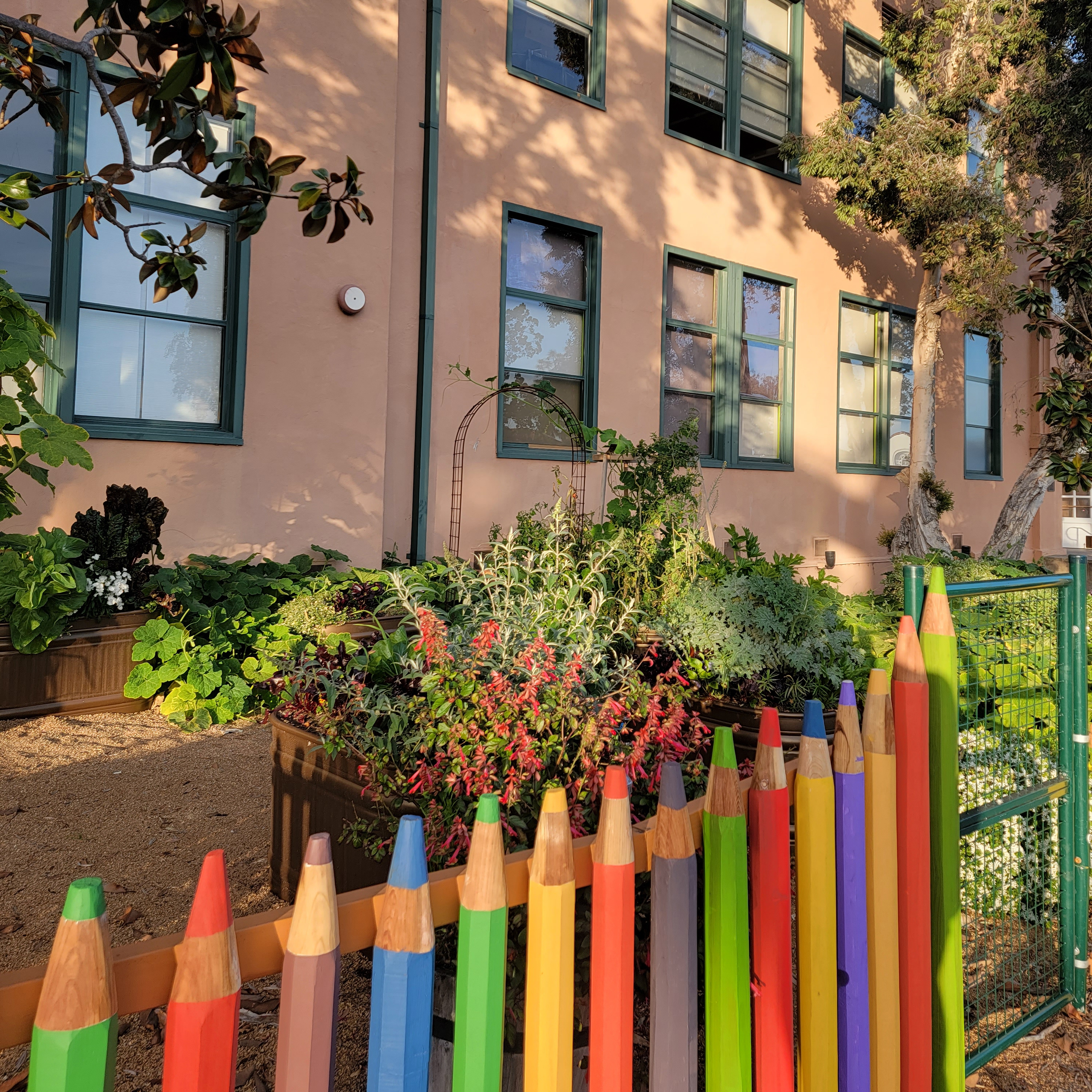 Organic Garden with bright colored handmade pencil fence at San Diego Craft Collective