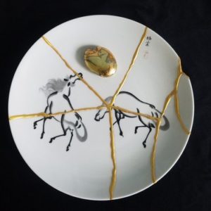 Kintsugi Embracing Imperfection black and white plate with gold on seams to repair