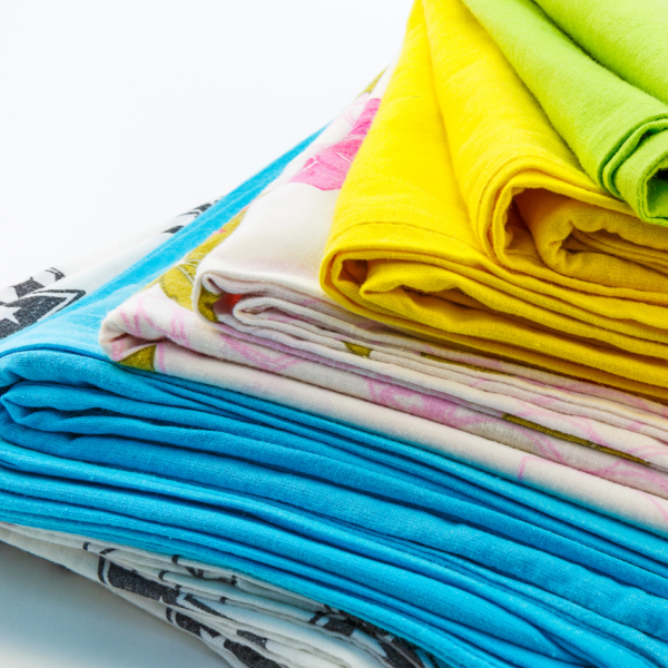 stack of colorful fabric on white table