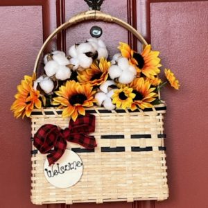 an examples of a door basket with flowers hanging on a red door