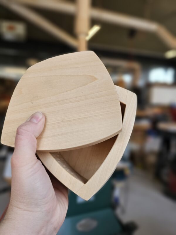hand holding a bandsaw box with lid