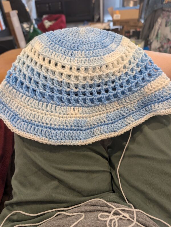 crochet hat on a person's lap