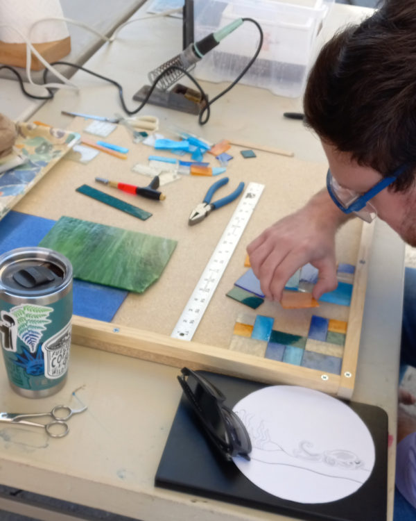 student working on stained glass project