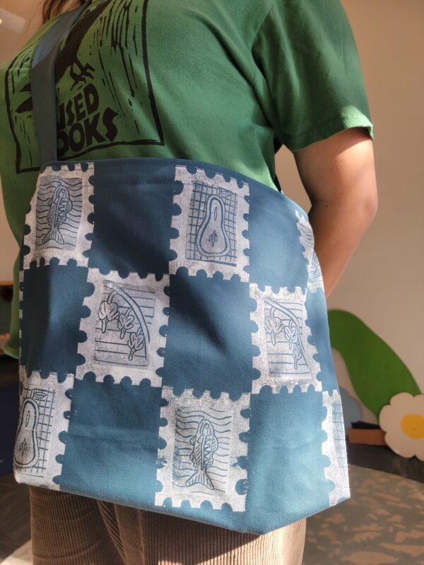 close-up of finished blockprinted blue bag hanging on woman