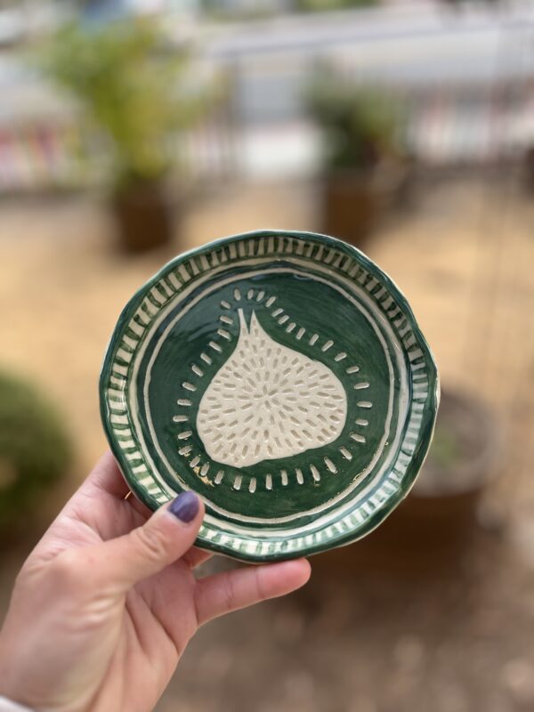 hand holding handmade bowl with surface design technique