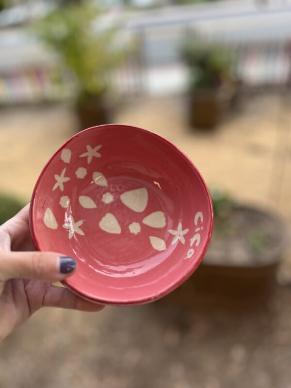 hand holding handmade bowl with surface design technique