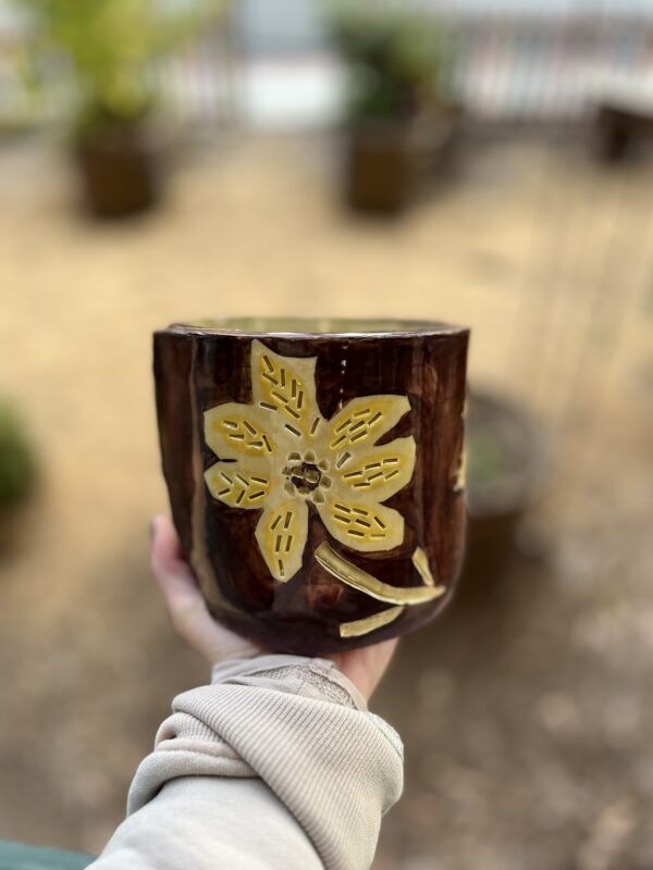 hand holding handmade bowl with surface design technique