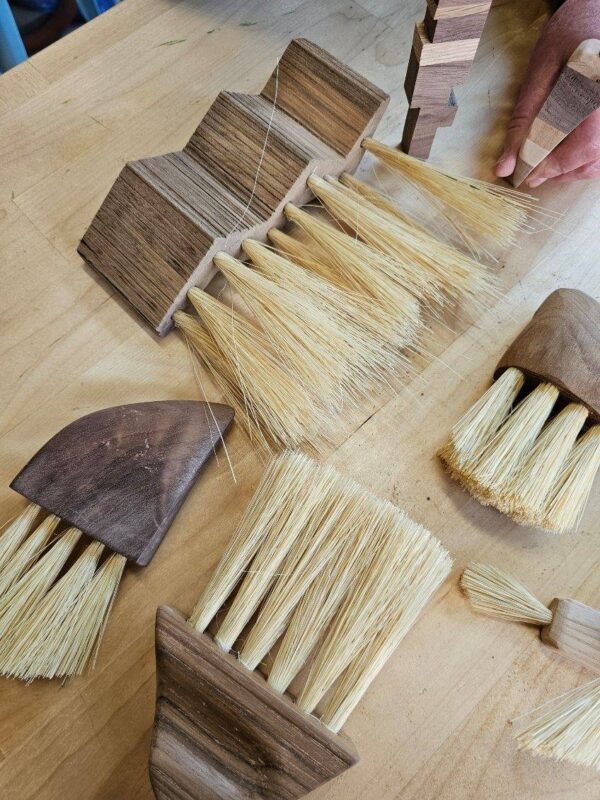 photo of handmade wooden brushes on workbench