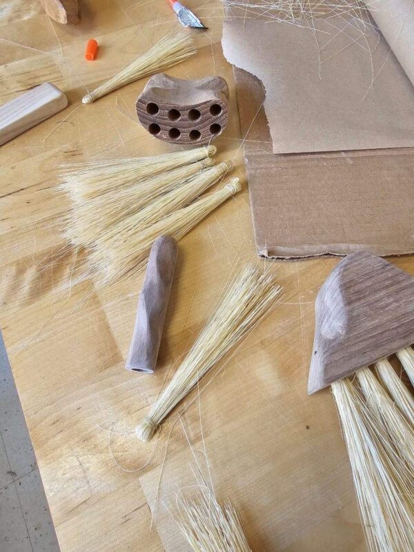 photo of handmade wooden brushes and tampico fibers on workbench