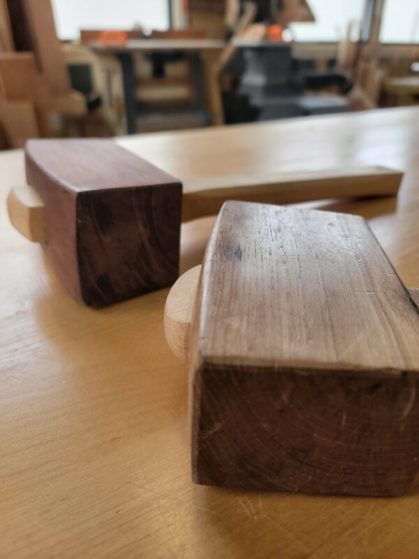 close up of two carpenter's mallets on workbench