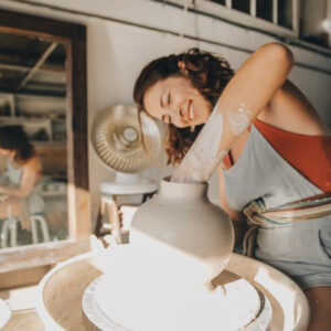 woman making handmade pottery on ceramic wheel