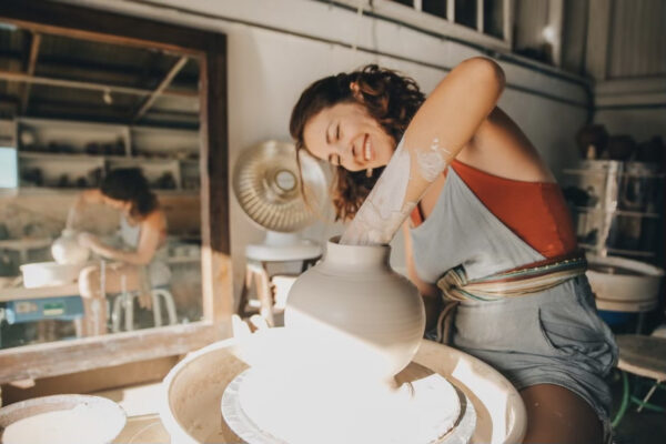 woman making handmade pottery on ceramic wheel