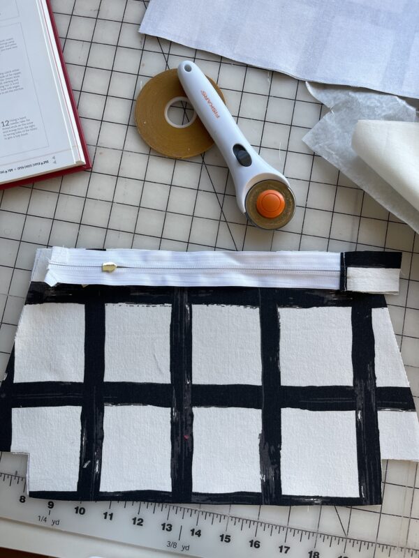 close up of a black and white fabric zipper pouch laid out to sew