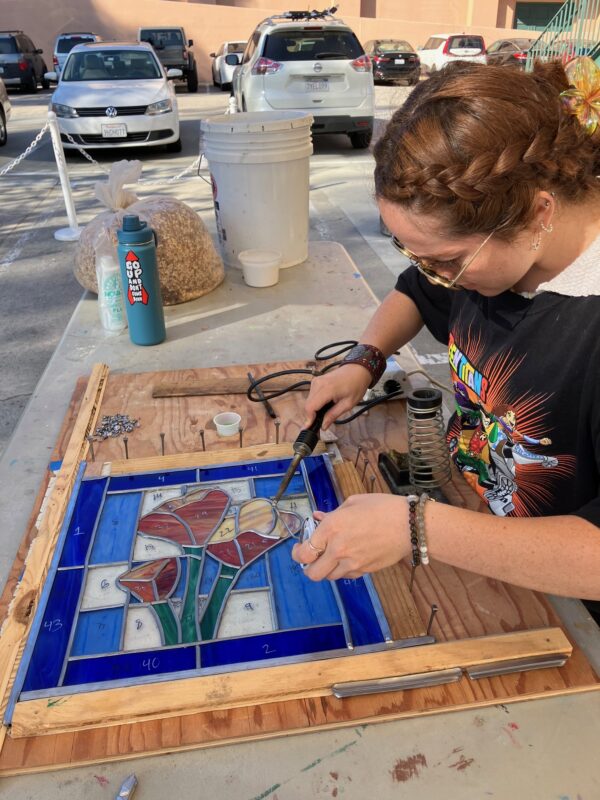 student working on a leaded stained glass piece