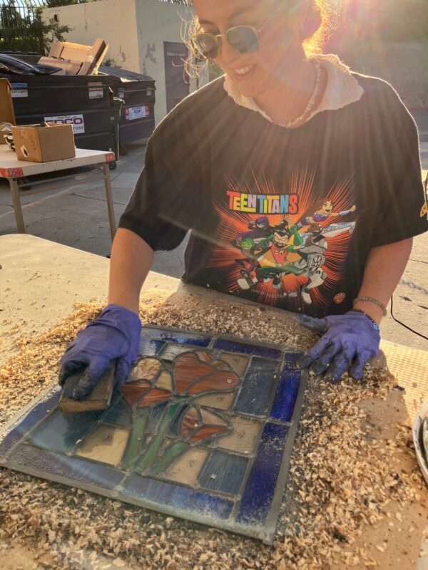 student working on a leaded stained glass piece