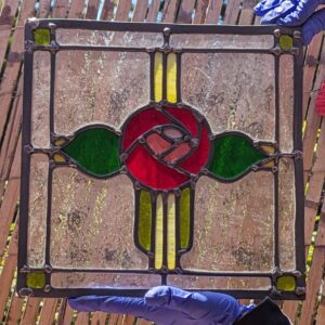 two hands holding a leaded stained glass piece