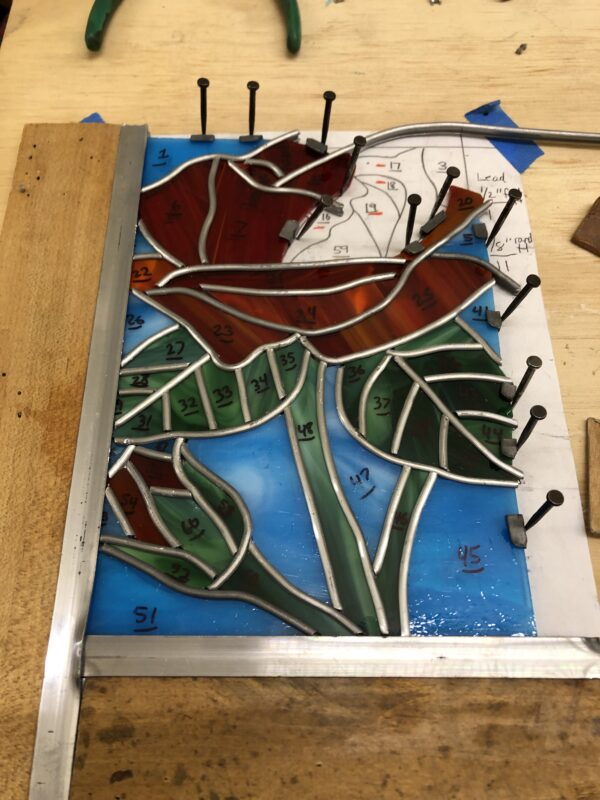 closeup of stained glass rose piece in progress