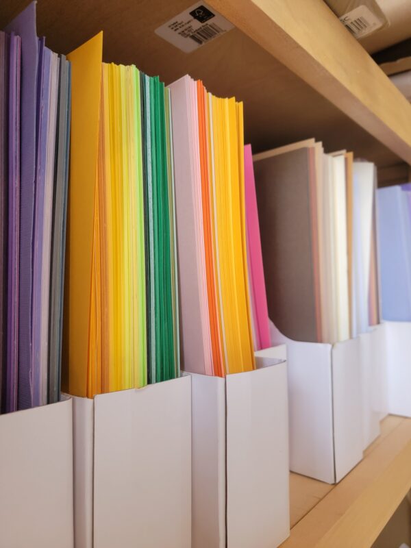 colored paper on shelves