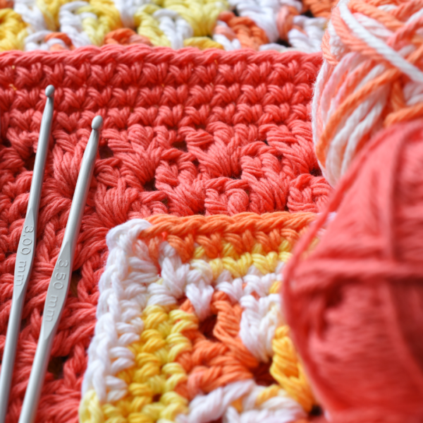 close up of crochet textile and crochet hooks