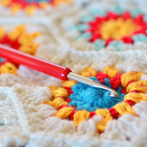 close up of crochet textile and crochet hook