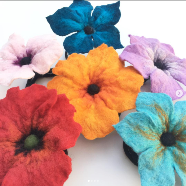 a group of colorful wet felted flowers