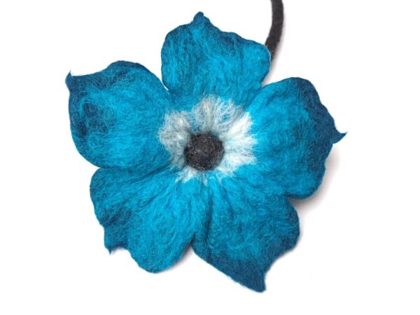 close-up of blue wet felted flower on white background