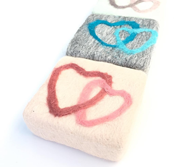 close up of wet felted soap bars with hearts on tops of each