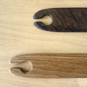 close up of a wooden stick shuttle for weaving