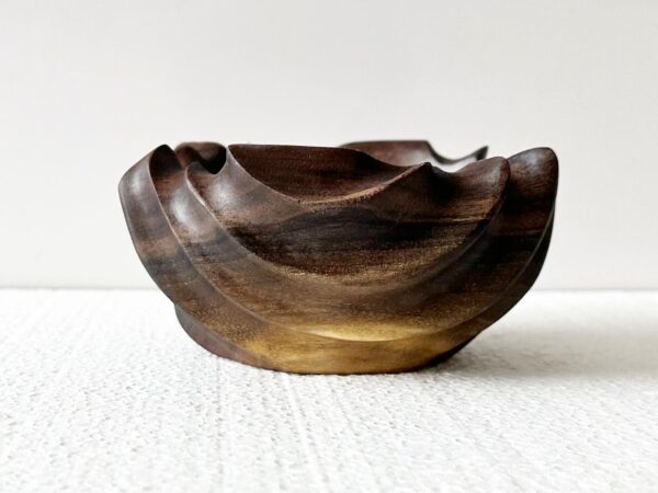 close up of dark colored power carved wooden bowl