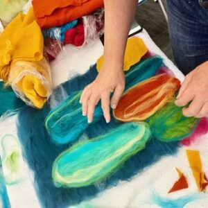 hands making a cactus with wool felted