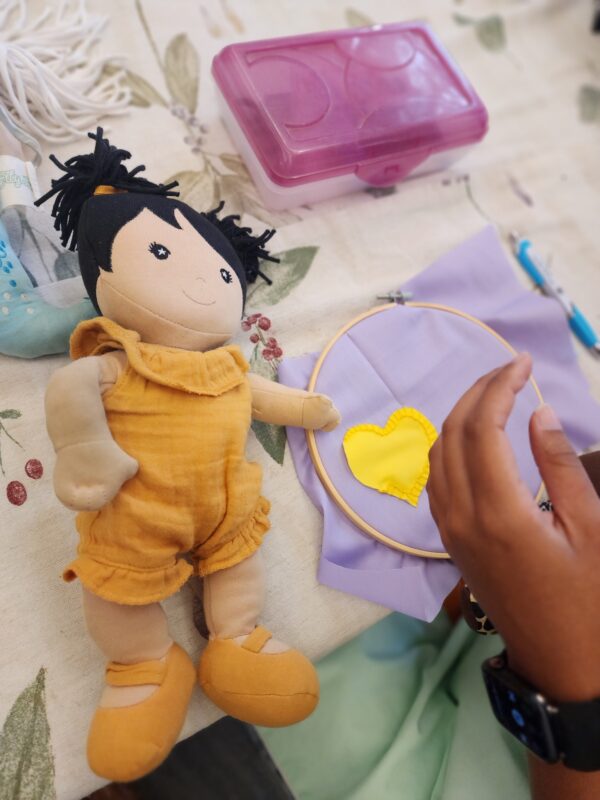 hands mending with plush toy doll