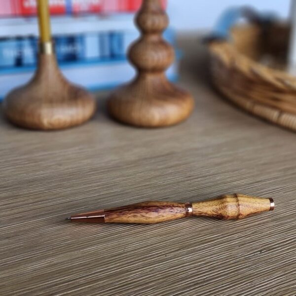 wooden pen laying on desk