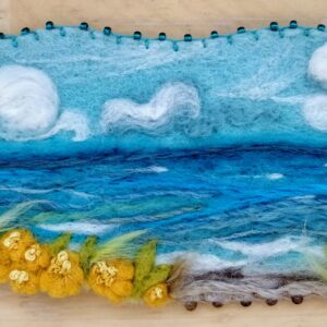 needle felted ocean scene of blue, green and yellows