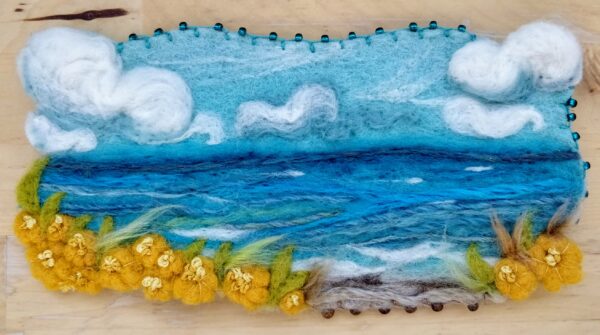 needle felted ocean scene of blue, green and yellows