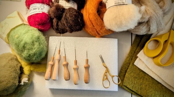 needle felting tools resting on a foam block