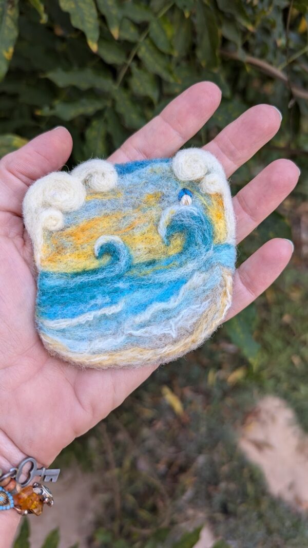 small seascape needle felted scene in the palm of a hand