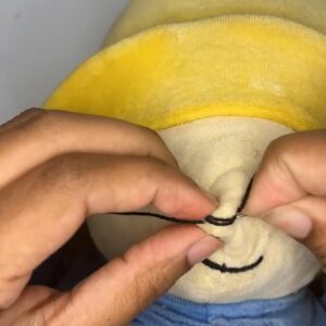 hands mending stuffed animal