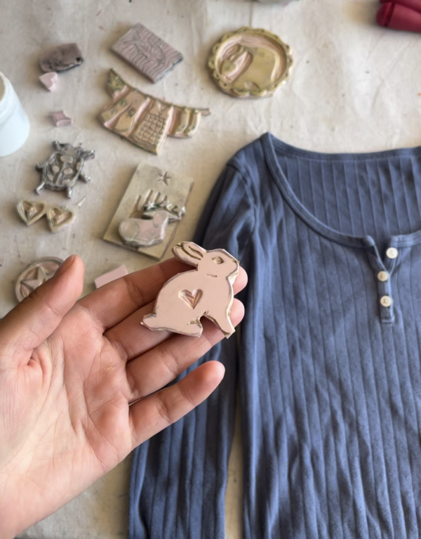 block printed shirt and lino carved stamp in hand