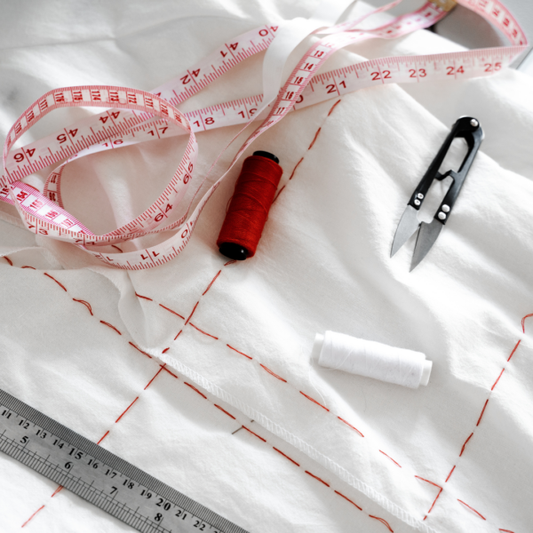 measuring tape, thread, scissors, chalk on fabric