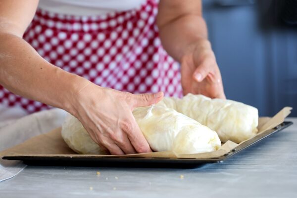 Woman preparing Austrian Strudel dough to bake