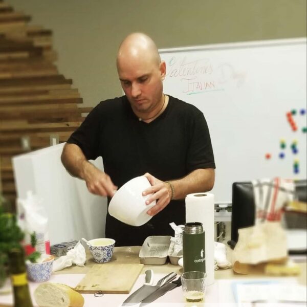 man stirring bowl of food