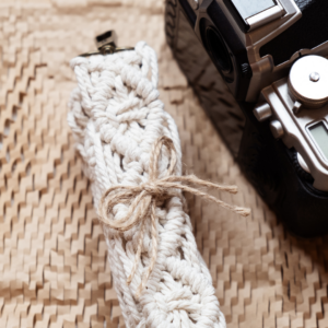 macrame strap next to old vintage camera