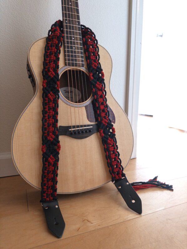 guitar resting against wall with custom macrame guitar strap