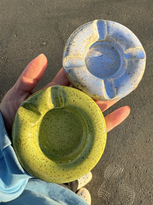 hand holding two ceramic glazed bowls