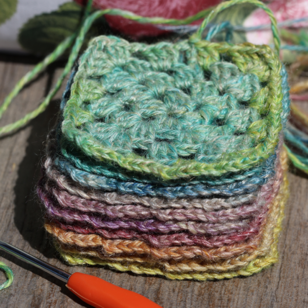 stack of colorful crochet granny squares