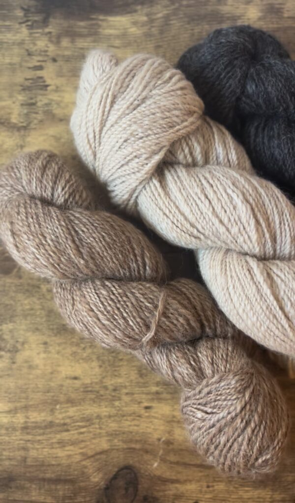 three skeins of handspun wool yarn
