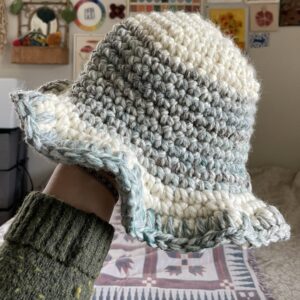 hand holding a crochet hat